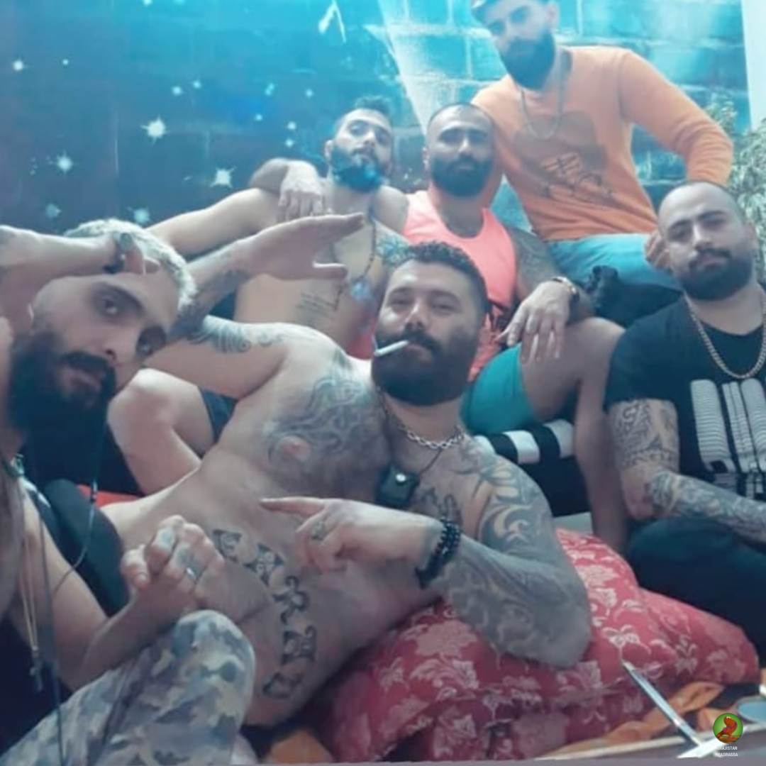 Tattooed men posing together in a relaxed indoor setting, Khajistan archive documentation.