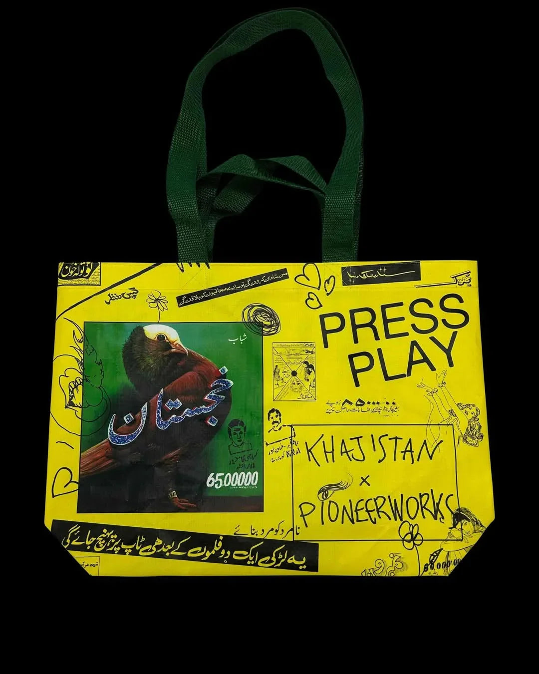 Khajistan x Pioneer Works yellow tote bag with Urdu text, eagle photo, and Press Play graphic